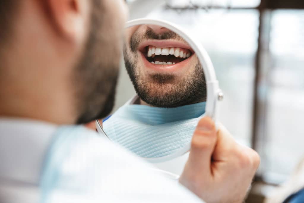 Man seeing his new smile for the first time